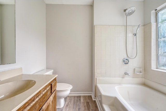 315 Indigo Rd, Goose Creek, SC 29445 - bathroom featuring washtub / shower combination, wood finished floors, toilet, vanity, and baseboards
