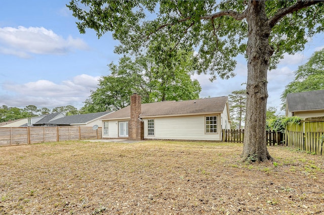 315 Indigo Rd, Goose Creek, SC 29445 - back of house with a fenced backyard and a chimney