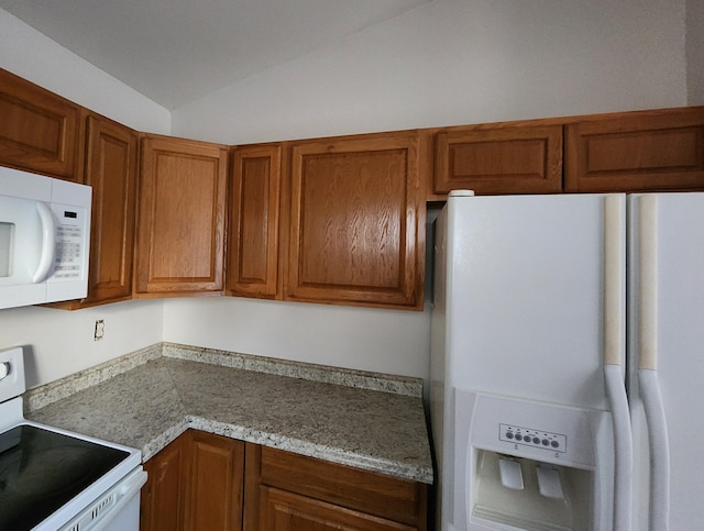315 Indigo Rd, Goose Creek, SC 29445 - kitchen featuring light stone countertops, brown cabinets, white appliances, and lofted ceiling