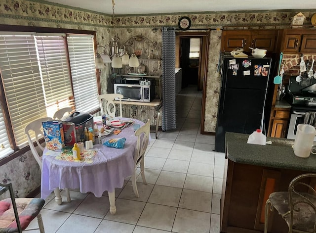 dining area with light tile patterned floors and wallpapered walls