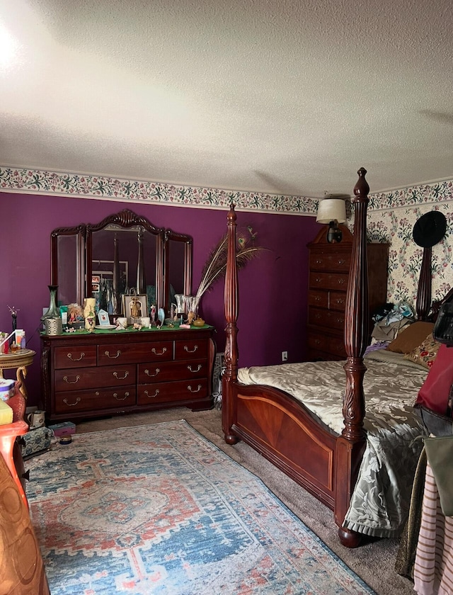 bedroom featuring a textured ceiling and carpet flooring