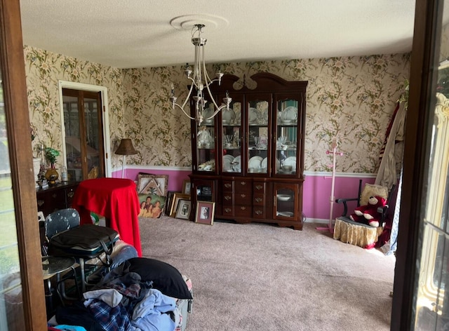 dining room with carpet flooring, a textured ceiling, and wallpapered walls