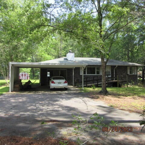 single story home featuring a carport