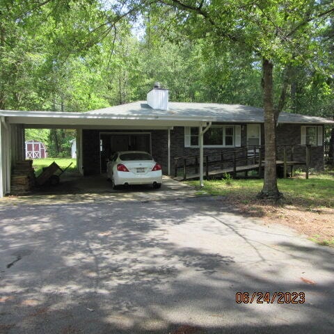 single story home with a carport