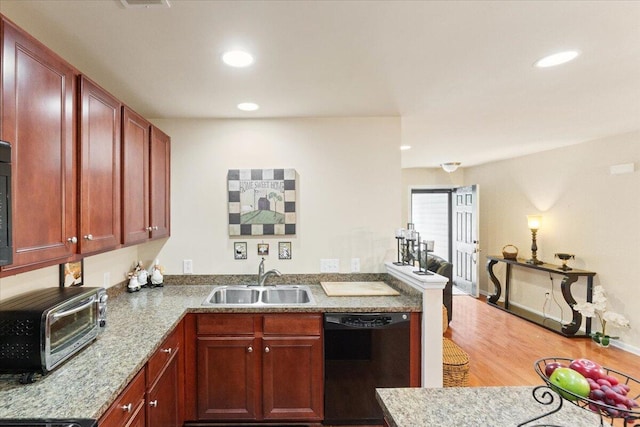 kitchen with recessed lighting, black dishwasher, a toaster, and a sink