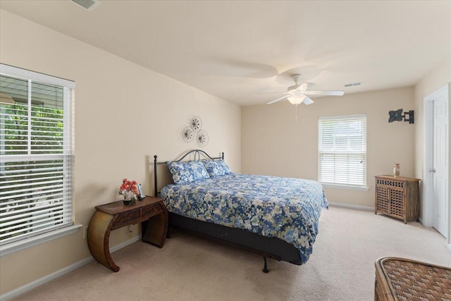 bedroom with carpet flooring, visible vents, baseboards, and ceiling fan