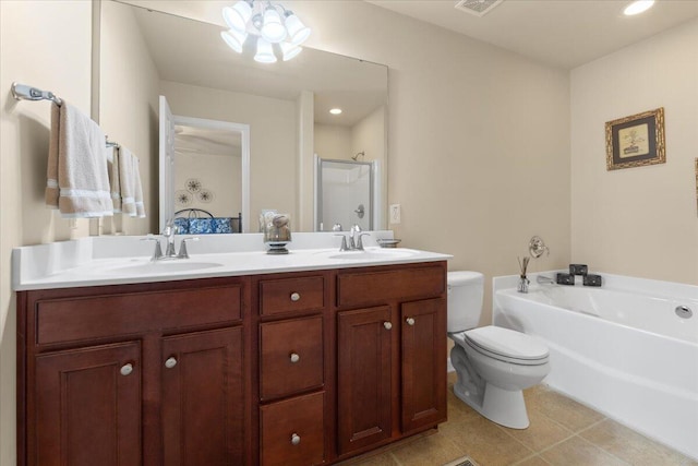 ensuite bathroom with double vanity, toilet, a garden tub, and a sink