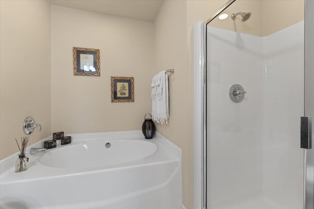 bathroom with a shower stall and a bath