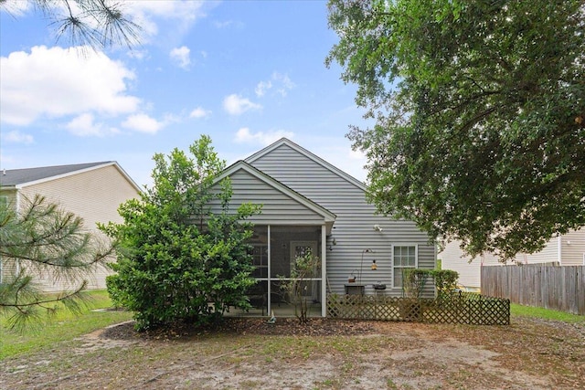 back of house with a sunroom and fence