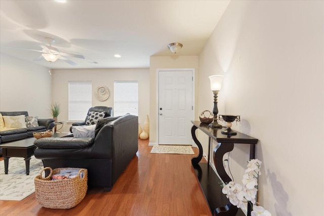 living area with recessed lighting, a ceiling fan, and wood finished floors