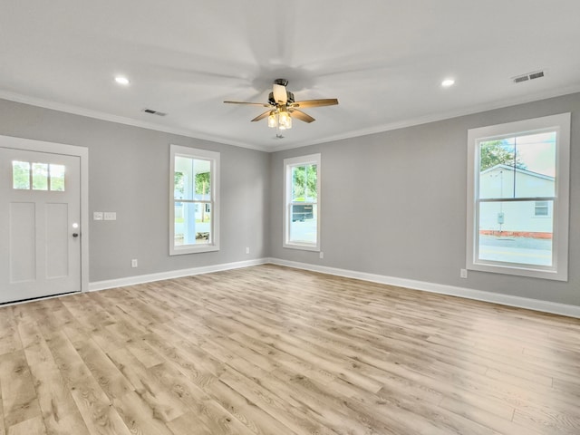 interior space with a wealth of natural light, ceiling fan, crown molding, and light hardwood / wood-style flooring