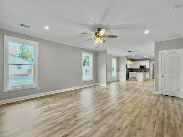 unfurnished living room featuring a healthy amount of sunlight and light hardwood / wood-style flooring