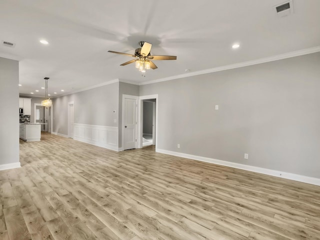 4566 Durant Ave, North Charleston, SC 29405 - unfurnished living room with recessed lighting, a ceiling fan, light wood-style floors, crown molding, and wainscoting