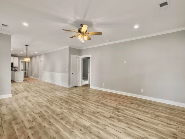 unfurnished living room with ceiling fan, ornamental molding, and light hardwood / wood-style flooring