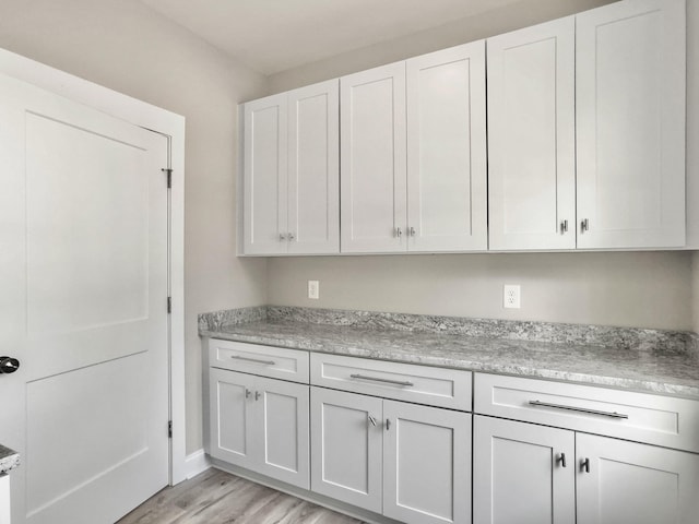 4566 Durant Ave, North Charleston, SC 29405 - kitchen featuring light wood-type flooring, white cabinetry, and baseboards