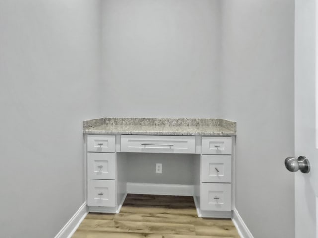 4566 Durant Ave, North Charleston, SC 29405 - unfurnished office with built in desk, light wood finished floors, and baseboards