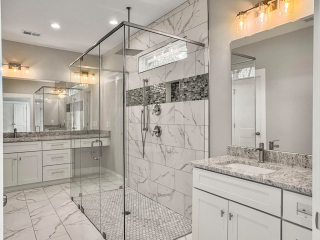 bathroom with an enclosed shower and vanity