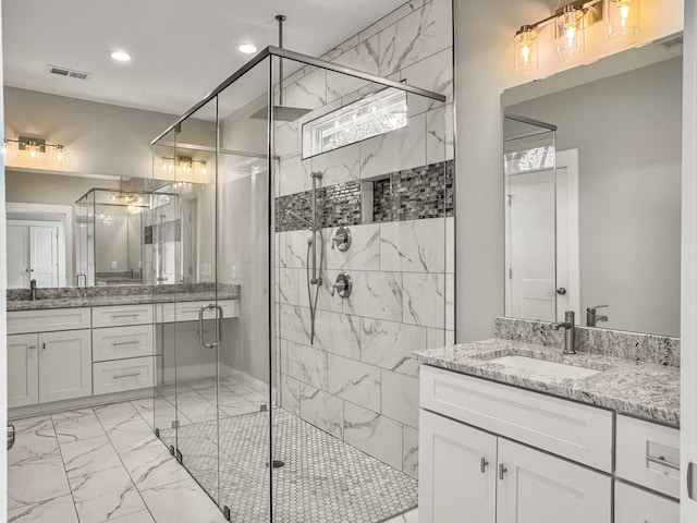 4566 Durant Ave, North Charleston, SC 29405 - bathroom with marble look tiles, a shower stall, healthy amount of natural light, two vanities, and recessed lighting