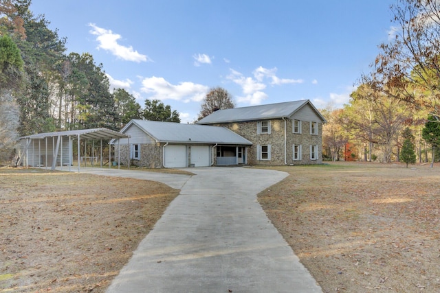 view of front of property featuring a garage and a carport