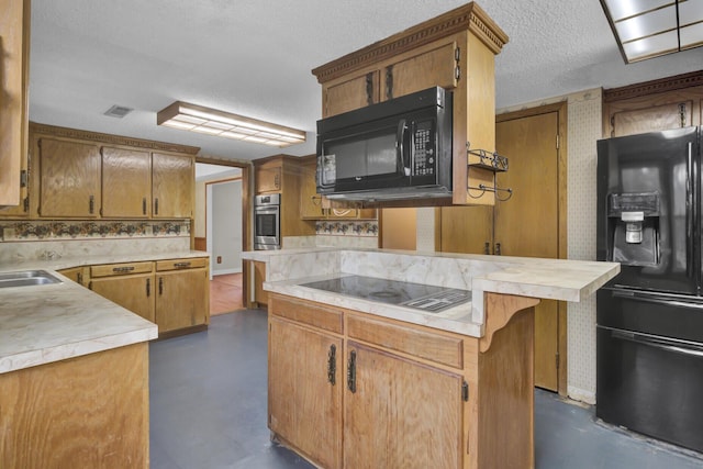 kitchen with a center island, black appliances, a kitchen breakfast bar, sink, and a textured ceiling