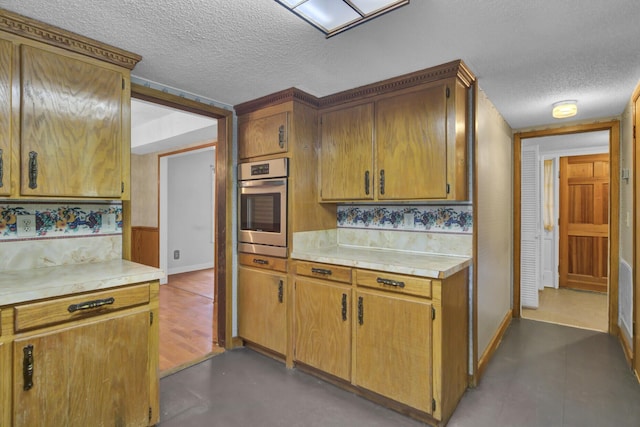 kitchen with oven and a textured ceiling