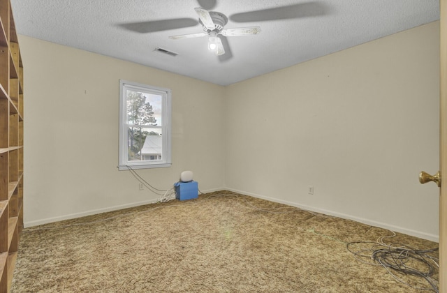 unfurnished room with carpet, ceiling fan, and a textured ceiling