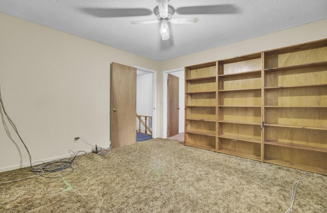 spare room with ceiling fan, carpet, and a textured ceiling