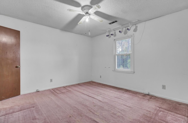 carpeted empty room with a textured ceiling and ceiling fan