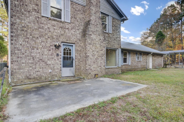 back of property featuring a yard and a patio area