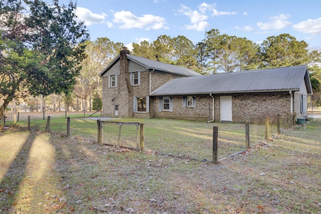 back of property featuring a lawn