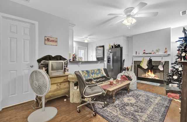 office space with ceiling fan and dark hardwood / wood-style flooring