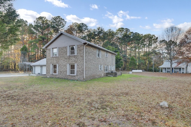 view of side of property with a lawn