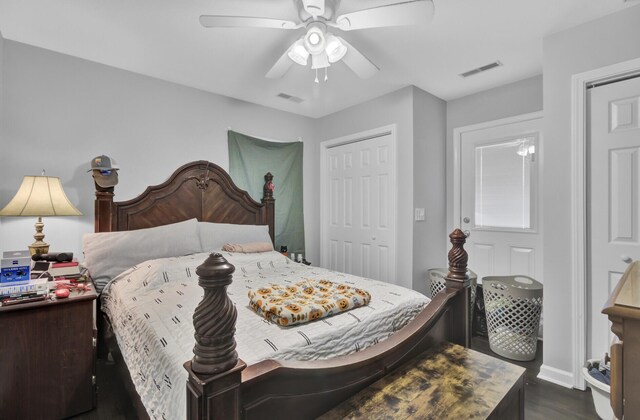 bedroom featuring ceiling fan, a closet, and dark wood-type flooring