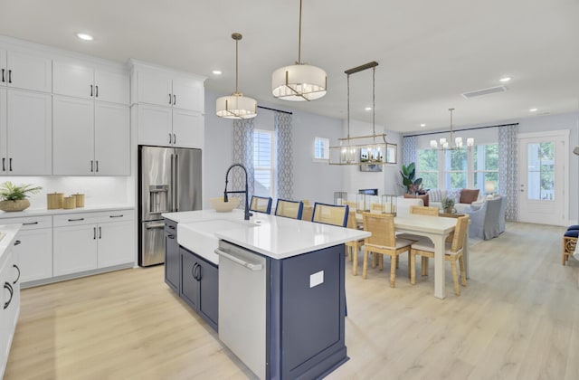 3041 Robeson Trce, Johns Island, SC 29455 - kitchen featuring a sink, appliances with stainless steel finishes, light wood-style floors, a chandelier, and light countertops