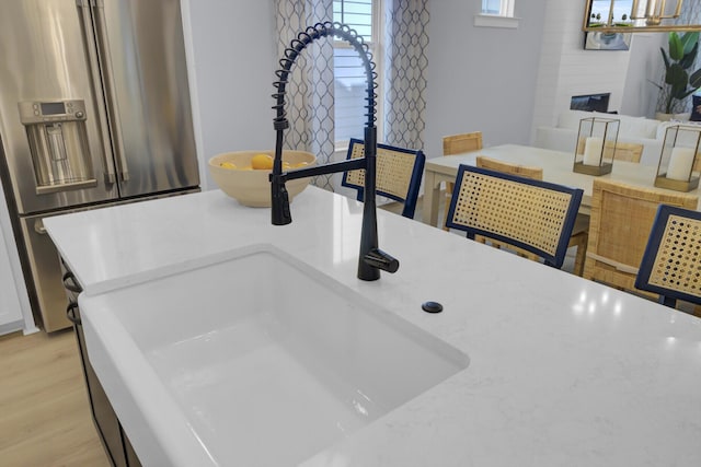 3041 Robeson Trce, Johns Island, SC 29455 - detailed view of high quality fridge, light wood-style flooring, light countertops, and a sink