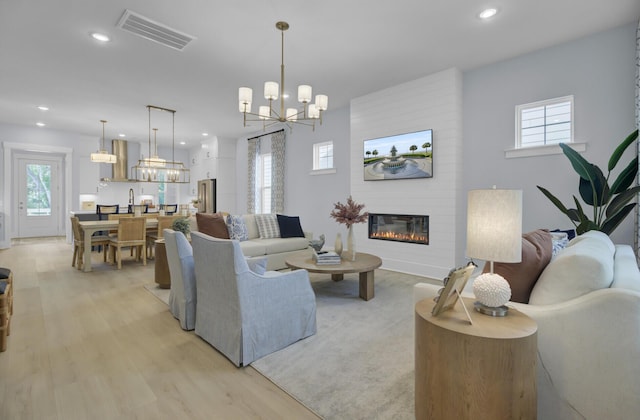 3041 Robeson Trce, Johns Island, SC 29455 - living room featuring a chandelier, a fireplace, light wood-style floors, healthy amount of natural light, and recessed lighting