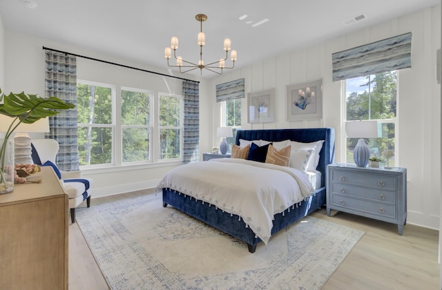 3041 Robeson Trce, Johns Island, SC 29455 - bedroom featuring a chandelier, light wood-style floors, and baseboards