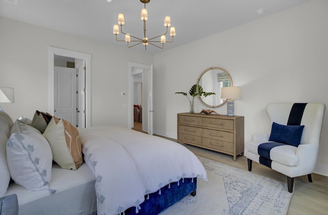 3041 Robeson Trce, Johns Island, SC 29455 - bedroom featuring a chandelier and light wood-style floors