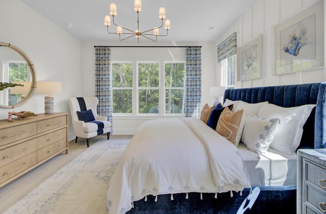 3041 Robeson Trce, Johns Island, SC 29455 - bedroom with a chandelier and light wood-style flooring