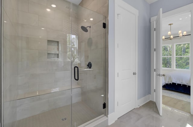 3041 Robeson Trce, Johns Island, SC 29455 - bathroom featuring a chandelier, ensuite bath, a stall shower, and baseboards