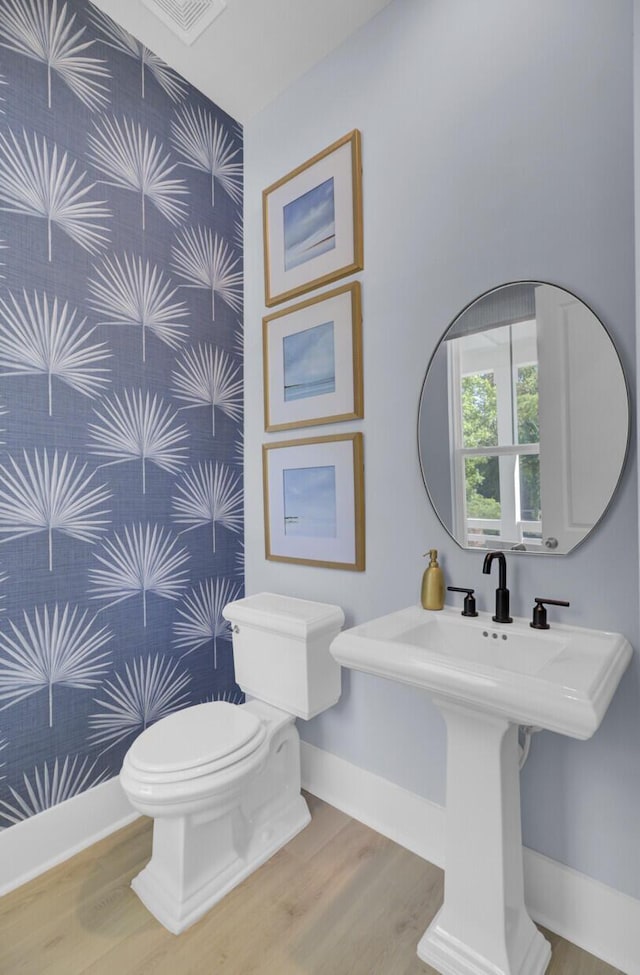 3041 Robeson Trce, Johns Island, SC 29455 - half bathroom with wood finished floors, toilet, baseboards, and a sink
