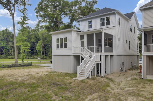 3041 Robeson Trce, Johns Island, SC 29455 - back of house featuring a sunroom, stairway, and central AC