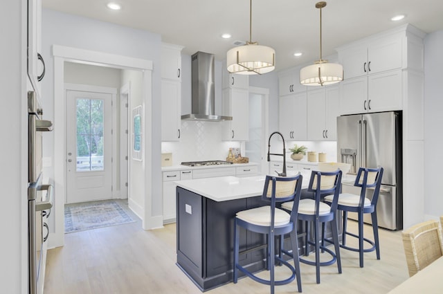 3041 Robeson Trce, Johns Island, SC 29455 - kitchen featuring wall chimney range hood, appliances with stainless steel finishes, light wood-style floors, light countertops, and recessed lighting