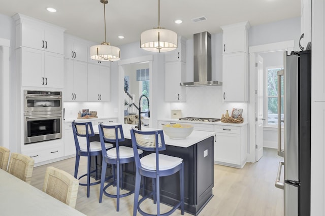 3041 Robeson Trce, Johns Island, SC 29455 - kitchen featuring wall chimney range hood, appliances with stainless steel finishes, light countertops, healthy amount of natural light, and recessed lighting