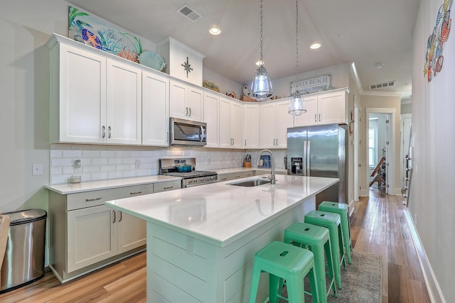 129 Howard Mary Dr Unit A, Charleston, SC 29412 - kitchen with appliances with stainless steel finishes, light countertops, decorative backsplash, a breakfast bar, and recessed lighting