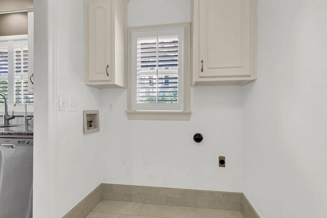 clothes washing area featuring sink, electric dryer hookup, cabinets, hookup for a washing machine, and tile patterned flooring