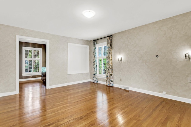 empty room with hardwood / wood-style floors