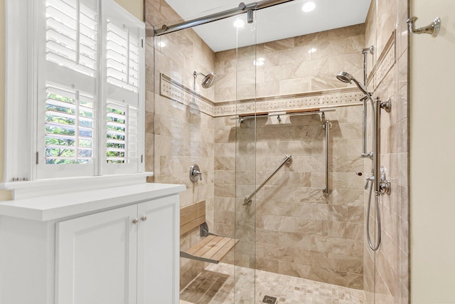 bathroom featuring vanity and a shower with shower door