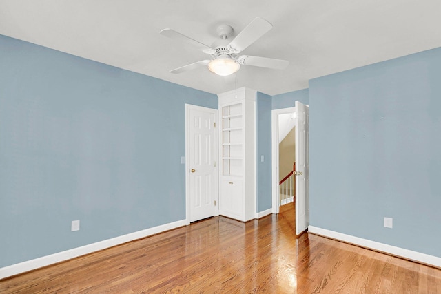 unfurnished bedroom featuring hardwood / wood-style flooring and ceiling fan