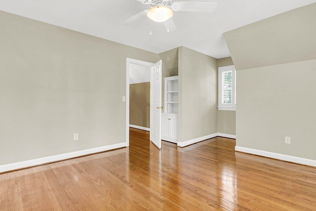 additional living space featuring hardwood / wood-style flooring, lofted ceiling, and ceiling fan